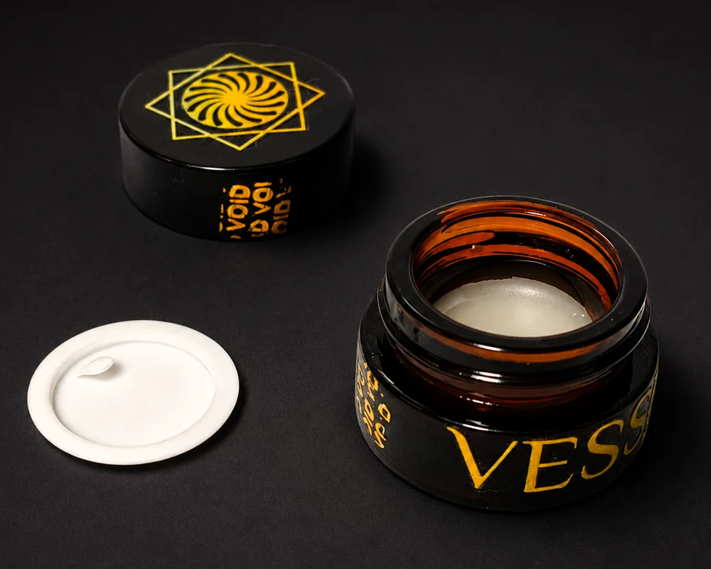 Open VESSENSE LE BAUME GRAND LARGE showing the removable inner protective disc and the colourless balm