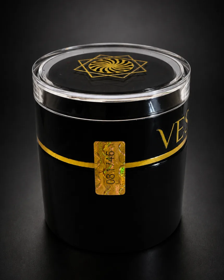 Numbered holographic control seal across the gold band of the VESSENSE jar